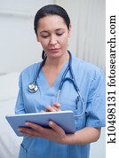 Nurse touching a tablet computer