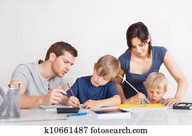 Parents helping their children with homework Parents helping their children with homework