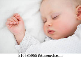 Peaceful baby lying on a bed while sleeping Peaceful baby lying on a bed while sleeping