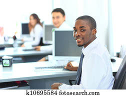 Portrait of a happy African American entrepreneur displaying computer laptop in office Portrait of a happy African American entrepreneur displaying computer laptop in office