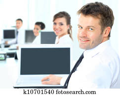 Portrait of a happy man entrepreneur displaying computer laptop in office Portrait of a happy man entrepreneur displaying computer laptop in office