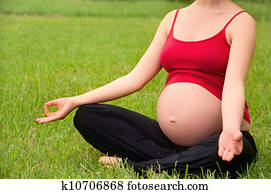 pregnant woman meditating in nature, practice yoga