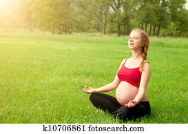 pregnant woman meditating in nature, practice yoga