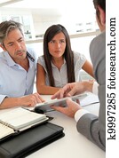 Real-estate agent showing house plans on electronic tablet