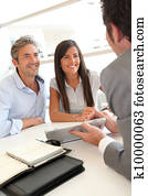 Real-estate agent showing house plans on electronic tablet