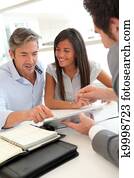 Real-estate agent showing house plans on electronic tablet