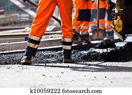 Road construction, worker with shovel Road construction, worker with shovel