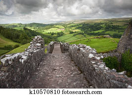 Ruined medieval castle landscape with dramatic sky