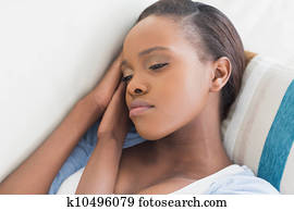 Sad black woman lying