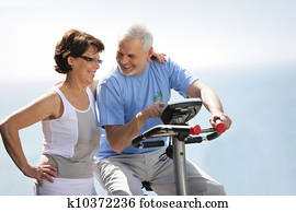 Senior couple with an exercise bike