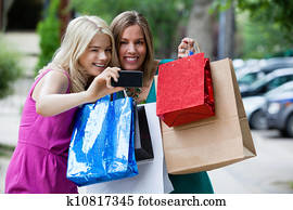 Shopping Women taking Photograph