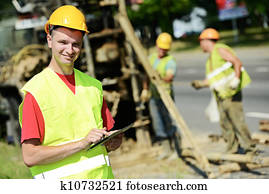 Smiling Engineer builder at road works site