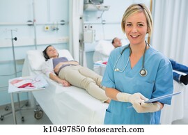 Smiling nurse next to transfused patients