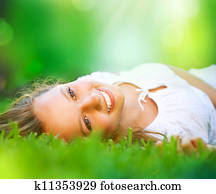 Spring Girl lying on the Field. Happiness 