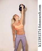 Strong Woman Lifting a Kettlebell