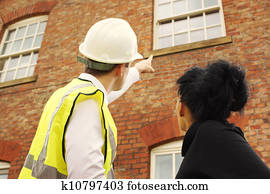Surveyor or builder and homeowner looking at a property Surveyor or builder and homeowner looking at a property