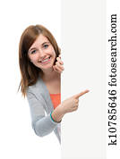 teenage girl points her finger at a blank board