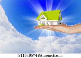 the house in hands on blue sky