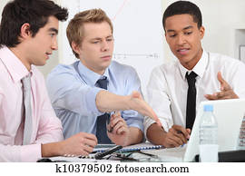 Three businessman working on a project.