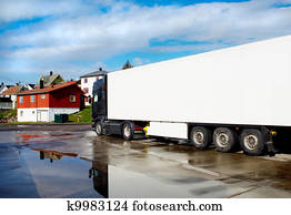 Truck on the streets of a small town after the rain
