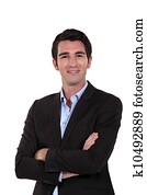 Upbeat businessman with arms folded