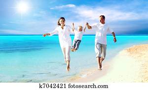 View of happy young family having fun on the beach