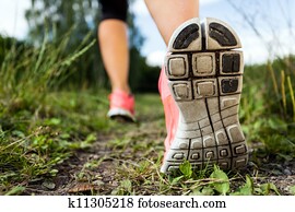 Walking or running legs in forest, adventure and exercising