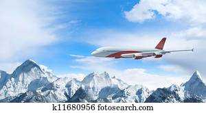 White passenger plane above the mountains White passenger plane above the mountains
