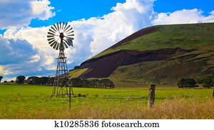 Windmill on a farm with volcanic mountain in the background