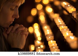 Woman praying in Catholic church Woman praying in Catholic church