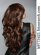 woman with long brown curly hair