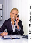 woman with phone in office