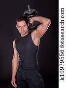 Young Attractive Man Pumping Weights