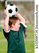 Young boy playing soccer