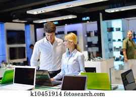 Young couple in consumer electronics store