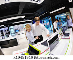 Young couple in consumer electronics store