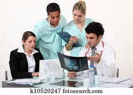 young physician surrounded by male and female nurse
