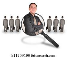 A business man is smiling inside of a magnifying glass. There are other business men turned and standing. Use it for a job search, employee candidate promotion or advantage concept.