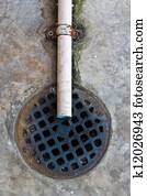 A round grille sewage and plastic water pipe.