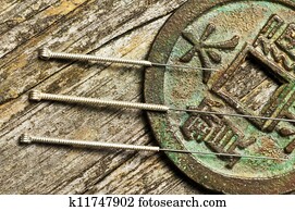 acupuncture needles on chinese coin