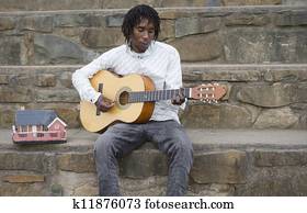 African busker playing guitar African busker playing guitar