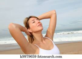 Beautiful woman breathing fresh air at the beach Beautiful woman breathing fresh air at the beach