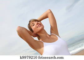 Beautiful woman breathing fresh air at the beach Beautiful woman breathing fresh air at the beach
