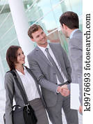 Business people meeting outside office building