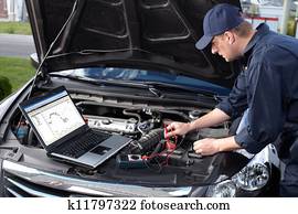Car mechanic working in auto repair service. Car mechanic working in auto repair service.