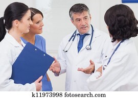 Doctor and nurse talking seriously Doctor and nurse talking seriously