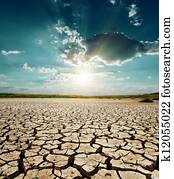 dramatic sunset over drought land