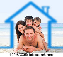 Family on the beach with blue house Family on the beach with blue house