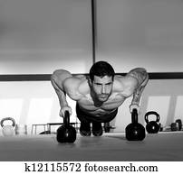 Gym man push-up strength pushup with Kettlebell Gym man push-up strength pushup with Kettlebell