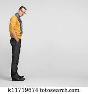 Handsome man casually leaning against the wall